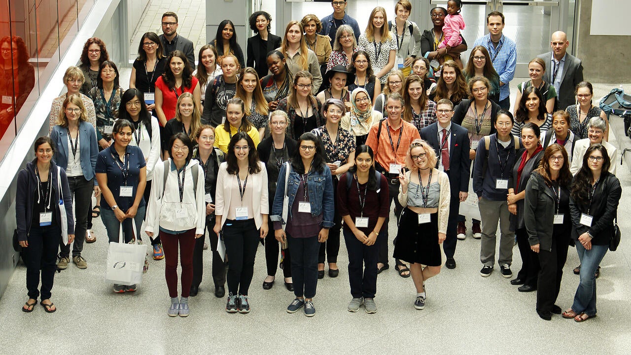 Conference attendees standing in lobby of Quantum Nano Centre