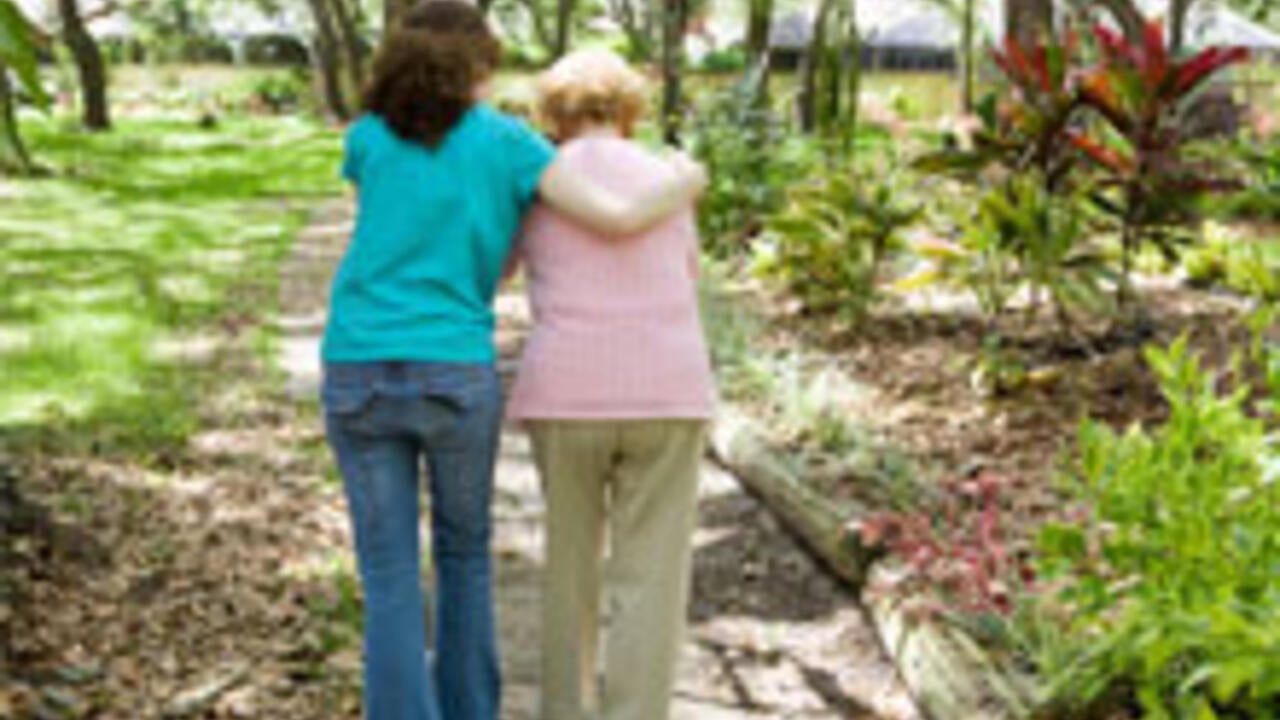 Young woman walks with a senior woman