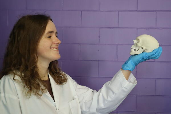 Elizabeth Diederichs, PhD candidate, holding a miniature skull that the research group 3D-printed using the new material.