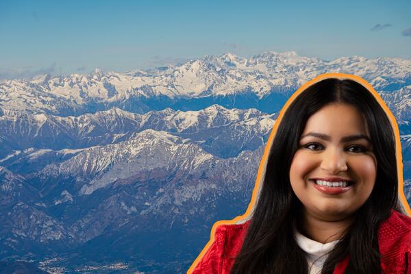 woman's smiling face with snowy mountains in background
