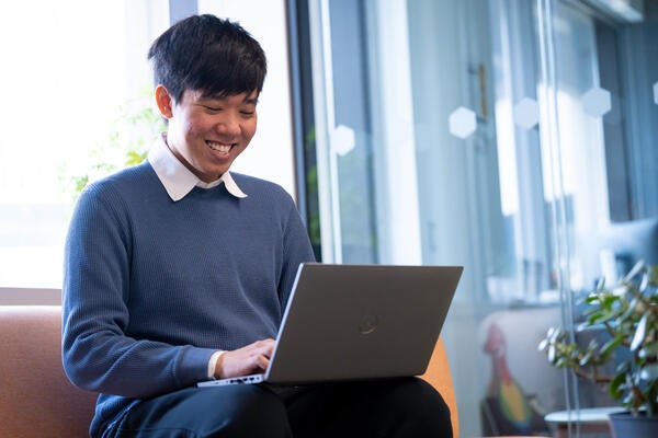 Hoang Do with a laptop