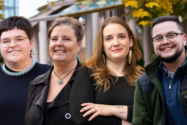Tara Ryan, Dale Bellaire, Savannah Sloat and Kian Drew pose in front of the Indigenous Outdoor Gathering Space.