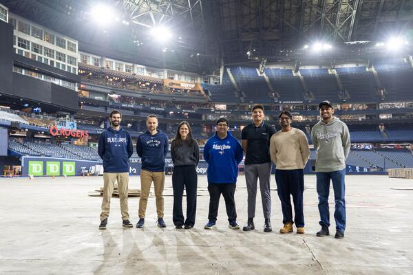 Group poses together on field level at Rogers Centre