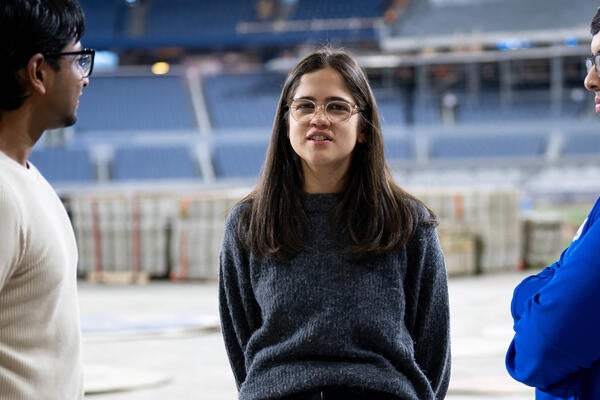 Gabrielle Campus speaks to other Waterloo alumni on the field at Rogers Centre