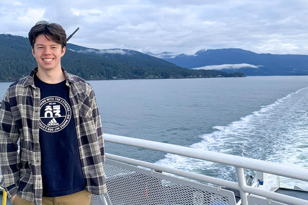 Thomas Coleman poses on the bow of a ferry between the Lower Mainland and Vancouver Island