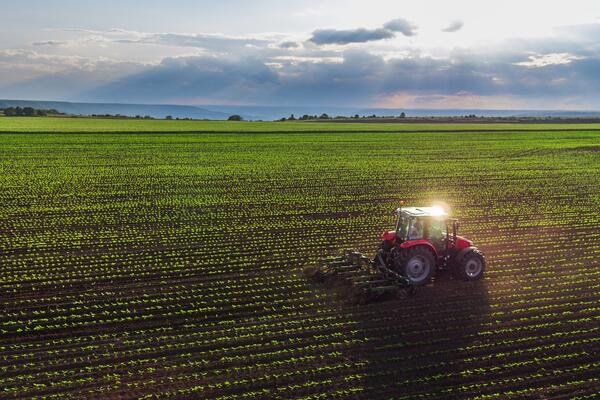 A tractor plows through a field