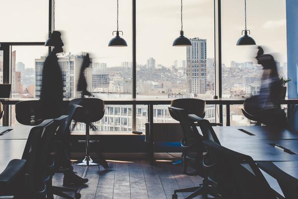 People walk across an office