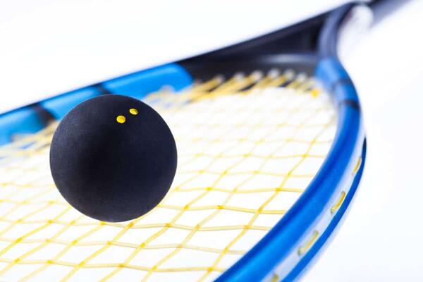 Squash ball on racquet