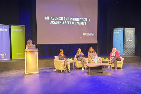 Panelists on stage at Antagonism in Academia event 