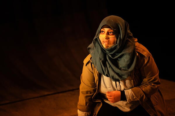 Woman with hijab and face mask on stage