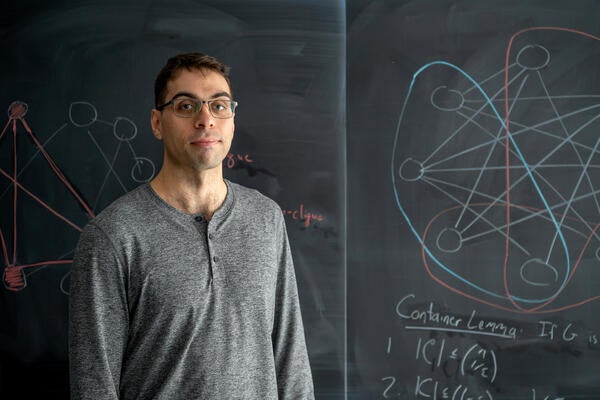 Cameron Seth standing in front of blackboard