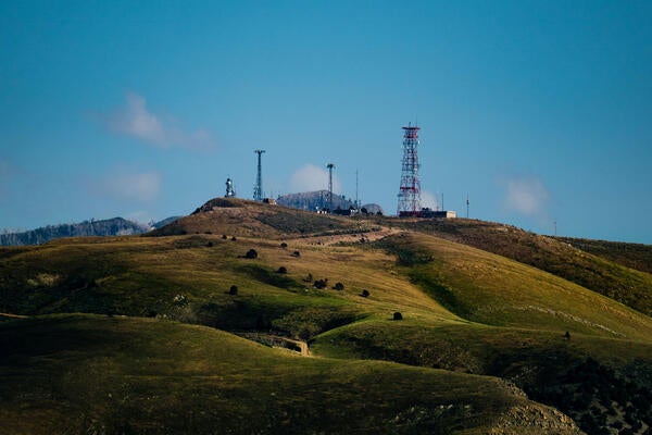 A hill with cellular towers in the distance