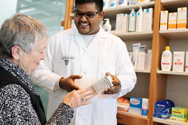 Waterloo pharmacy graduate assisting patient in a pharmacy