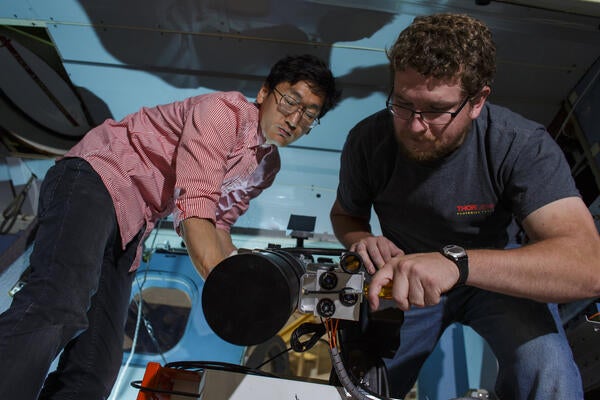 Postdoctoral fellow Jeongwan Jin and PhD candidate Christopher Pugh setting up Bob on the NRC Twin Otter Airborne Research Aircraft. (Source: NRC)