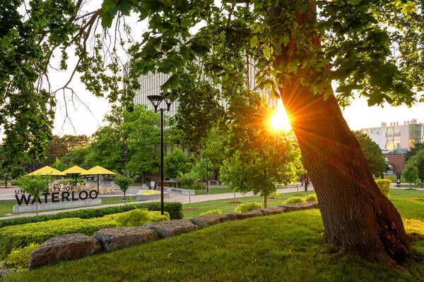 Sunset beside Dana Porter Library with Waterloo sign in the foreground