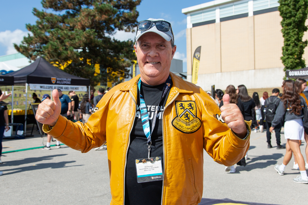 Eric poses at Homecoming with his leather Waterloo jacket