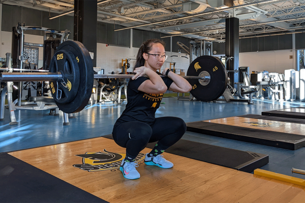 Evelyn Jiang lifts heavy weights in gym