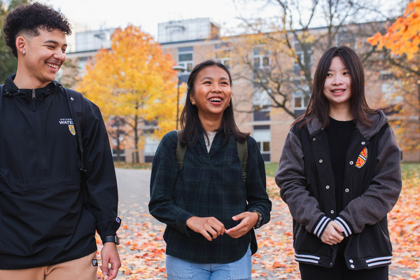 Three students walking on a fall day