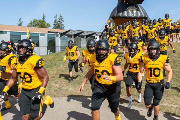 The Waterloo Warriors football team walking out to a game