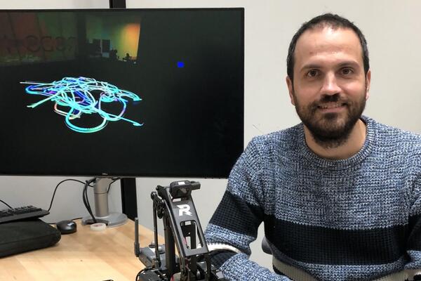 Dr. Gennaro Notomista, a University of Waterloo professor, with one of the robots that creates paintings inspired by music.