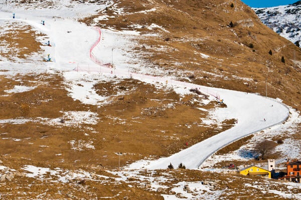 An image of a ski hill with little snow due to warmer weather conditions