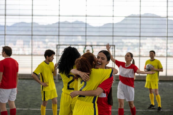 Players celebrating while playing a soccer game 