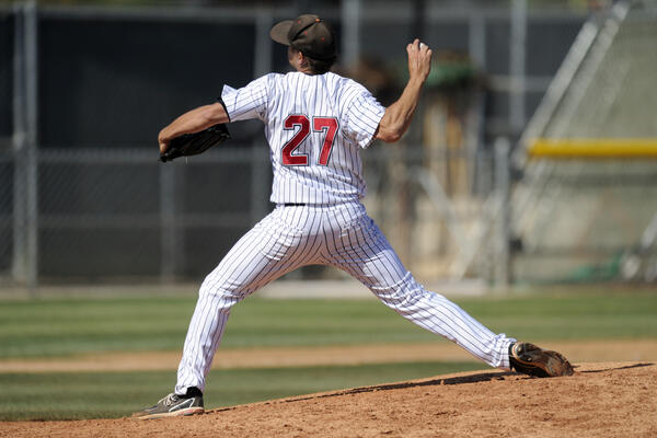 A baseball pitcher throws during a baseball game (Matt Brown/Getty Images). 