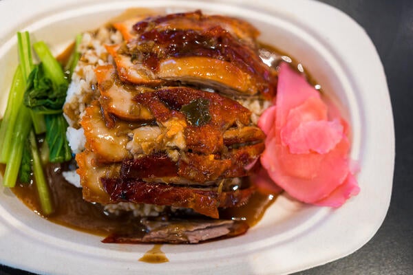 Roasted bbq duck with gravy sauce on top of rice