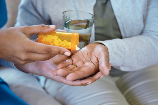 Nurse giving patient their pills