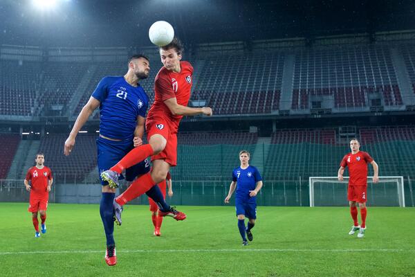 Soccer player jumping and heading the ball.