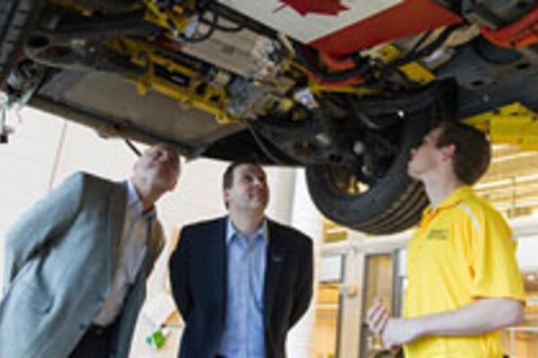 Vice President Ken Kelzer and Executive Director Brandon Vivian examine vehicle modifications
