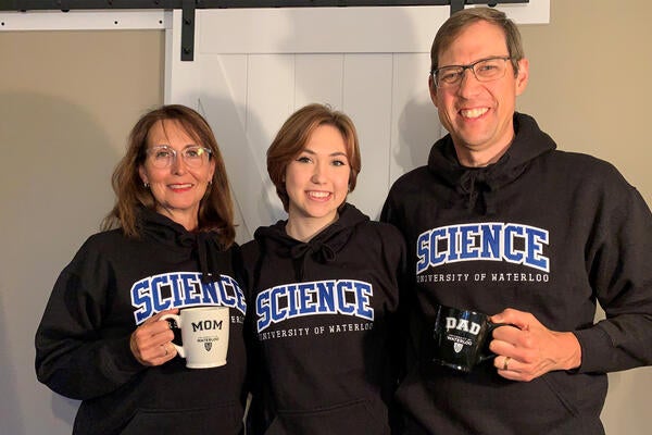 Jocelyn Hadden with her parents Susan and James, all in Waterloo Science sweaters