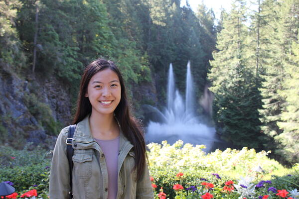 Kinesiology graduand Tina Jiao in front of a garden