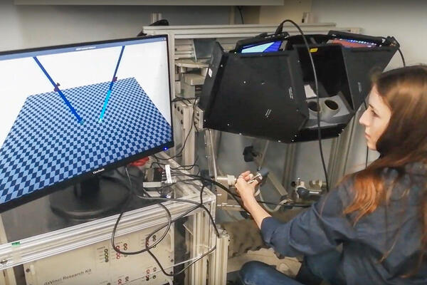 Ella Walsh in a lab at SickKids operating a robotic simulator