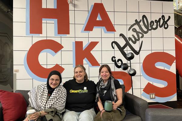 Malak Sameh, Erin Hogan and Lily Viggiano sitting inside the Communitech building