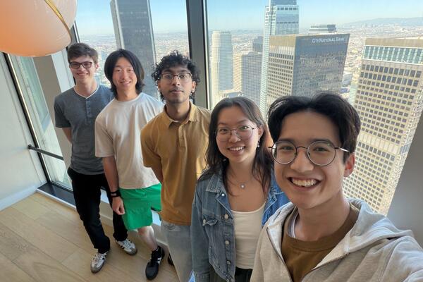 Atoms co-op students pose for photo at the Atoms office with cityscape in the overshoot