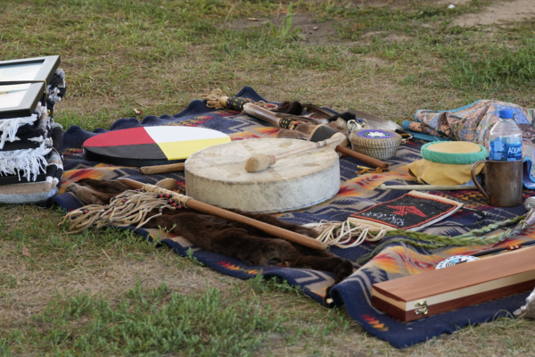 A drug and various Indigenous items on a blanket