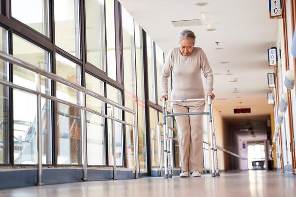 Older person with walker in hallway