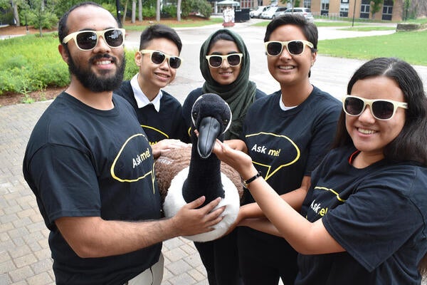 A group of Library ambassadors hold a stuffed Canada goose