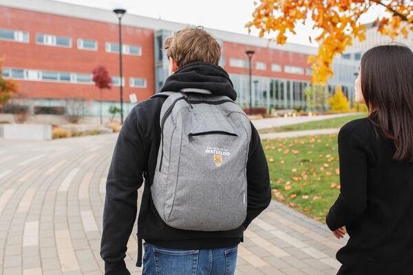 Two students walking towards a building on campus