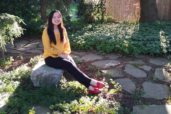 Maggie Chang sitting in a garden