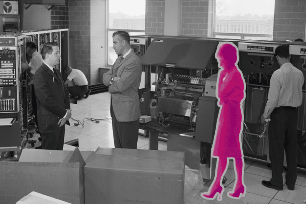 A black and white photo of Wes Graham's computer group, with a pink woman's silhouette superimposed