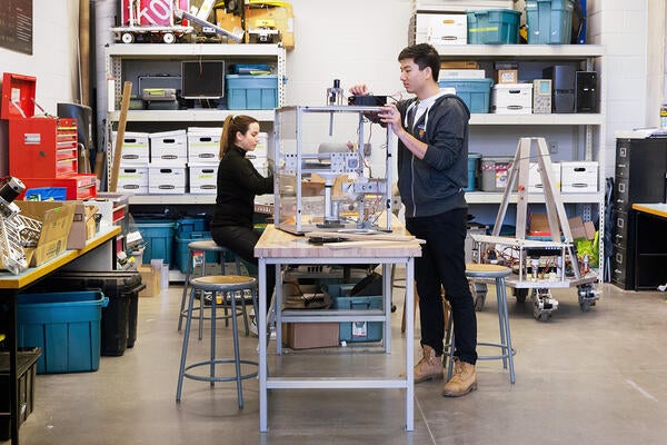 Two students working on robotics