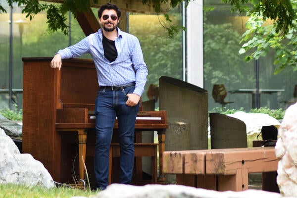 Max standing beside piano