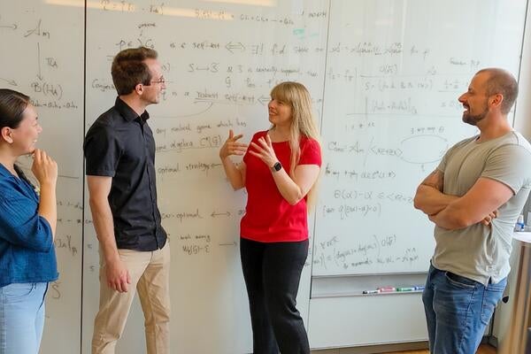 Dr. Christine Muschik with researchers of the qudit quantum computer project