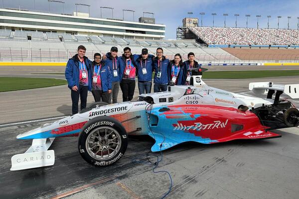 University of Waterloo students pose with their self-driving race car in Las Vegas.