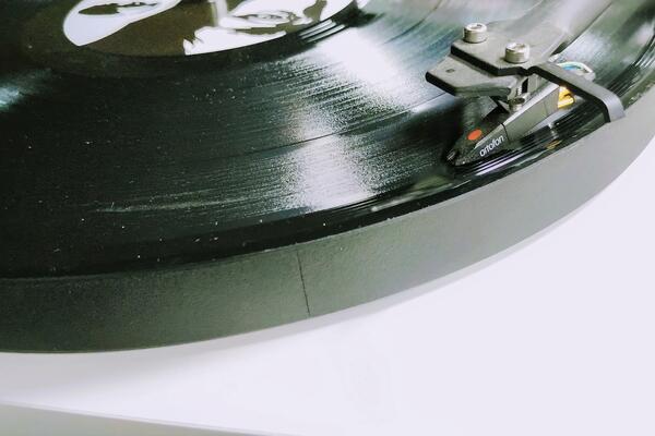 An old-school vinyl album plays on a turntable.