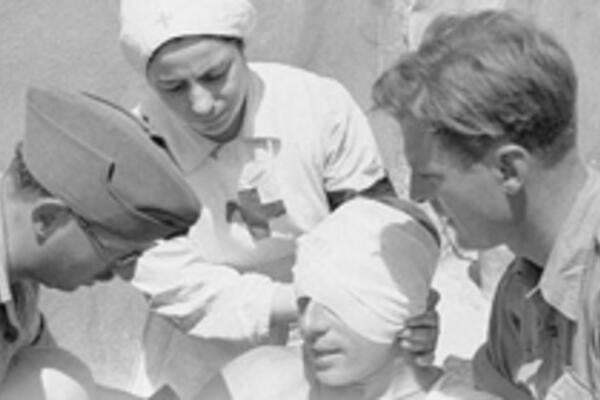 Doctors and nurse aid an injured man during World War 1