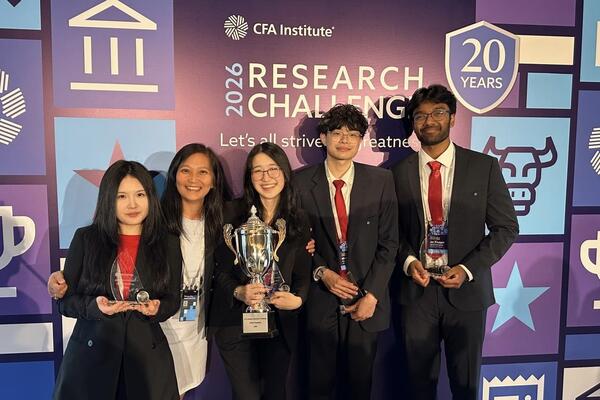 five young people holding trophies in front of CFA competition backdrop