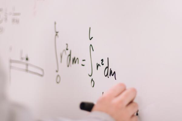 Hand writing on a whiteboard